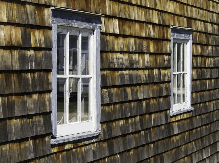 Pair of weathered windows in exterior wall of cedar shakes.jpeg